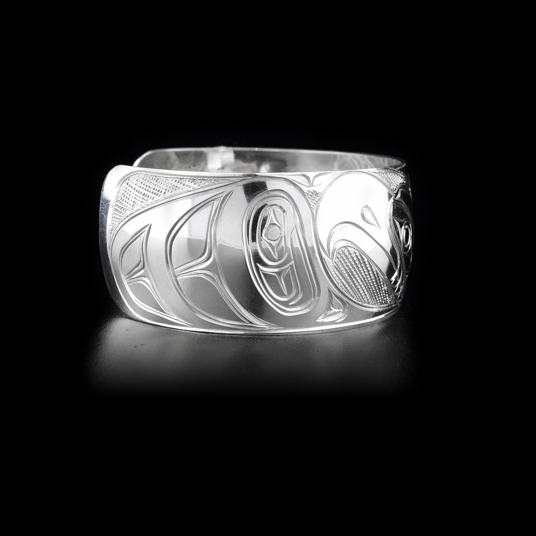 Right side of sterling silver cuff bracelet featuring eagle body and part of head.