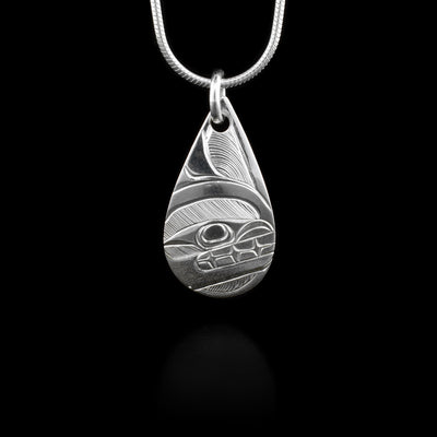 This sterling silver pendant is teardrop shaped and has a depiction of the Orca carved into it.