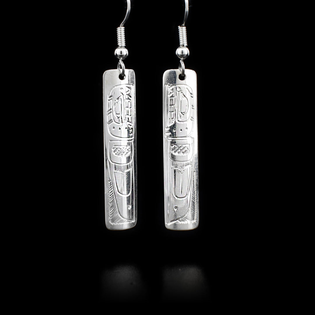 Long, rectangular sterling silver dangle earrings featuring orcas. By Coast Salish artist Gilbert Pat.
