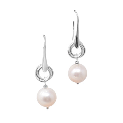 For each earring, a cream freshwater pearl dangles below an adornment with overlapping loops. Earrings have ear hooks. Made using sterling silver.