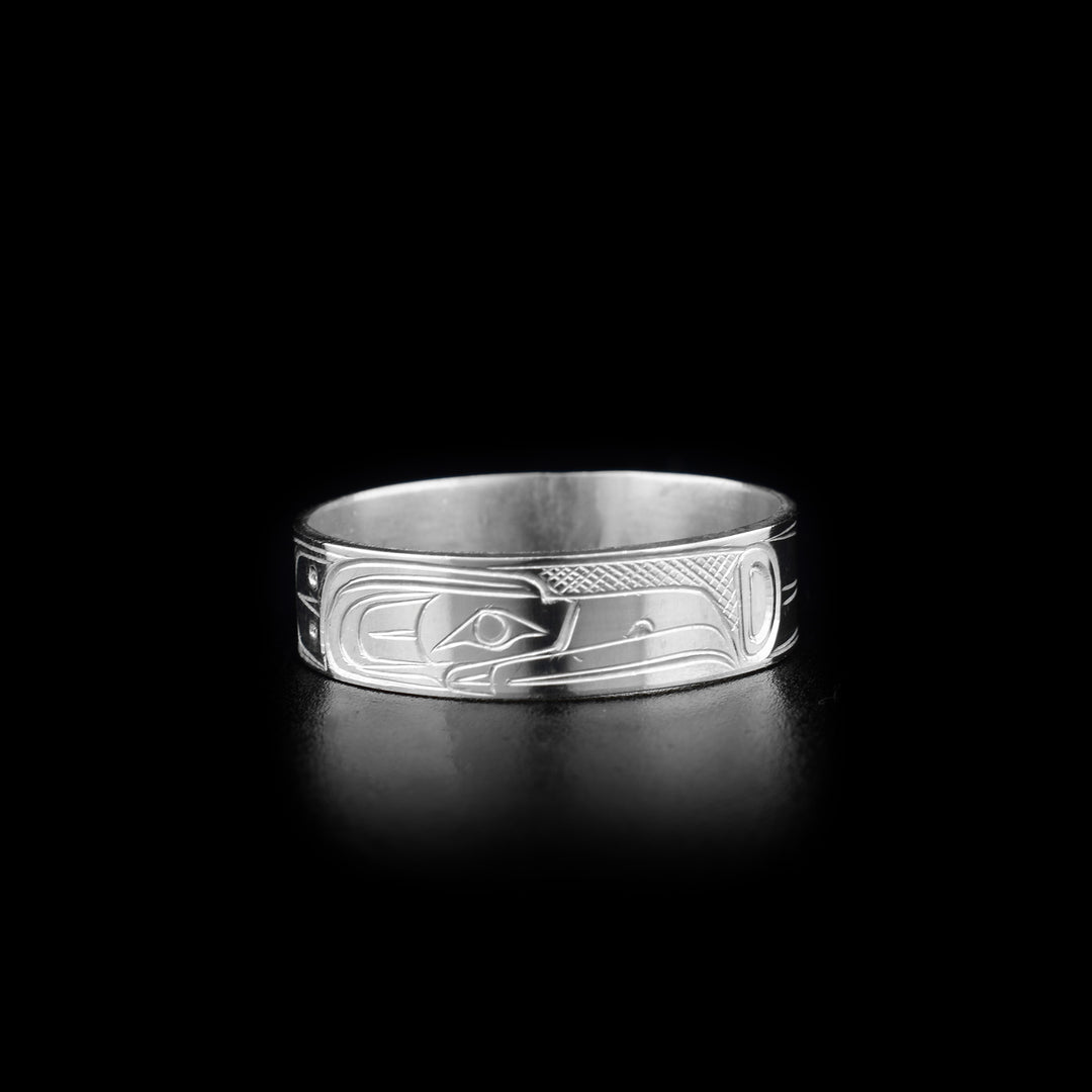This photo shows the silver Raven ring with carvings in the center depicting the head of the Raven with its long, thin beak. On either side are its wings.