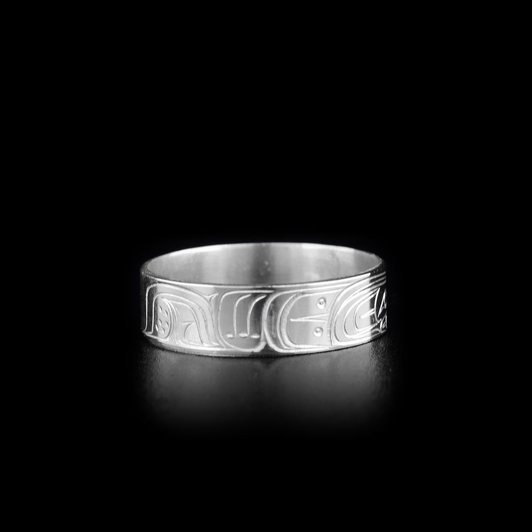 This photo shows the left side of the silver Raven ring and shows carvings depicting the Raven's wing.