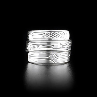 This wrap ring has three layers with the middle layer depicting the head of a raven facing the right. The rest of the band has carvings depicting the bird's feathers.
