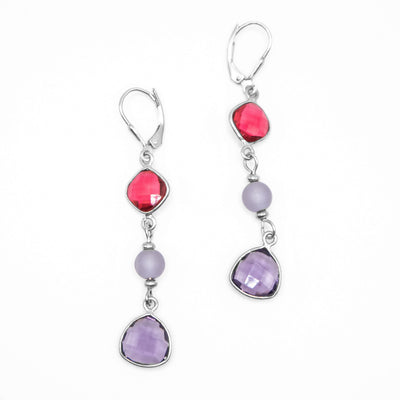 Lever-back hooks with flat, faceted ruby quartz above round, lavender sea glass bead above flat, faceted amethyst. Metal is sterling silver.