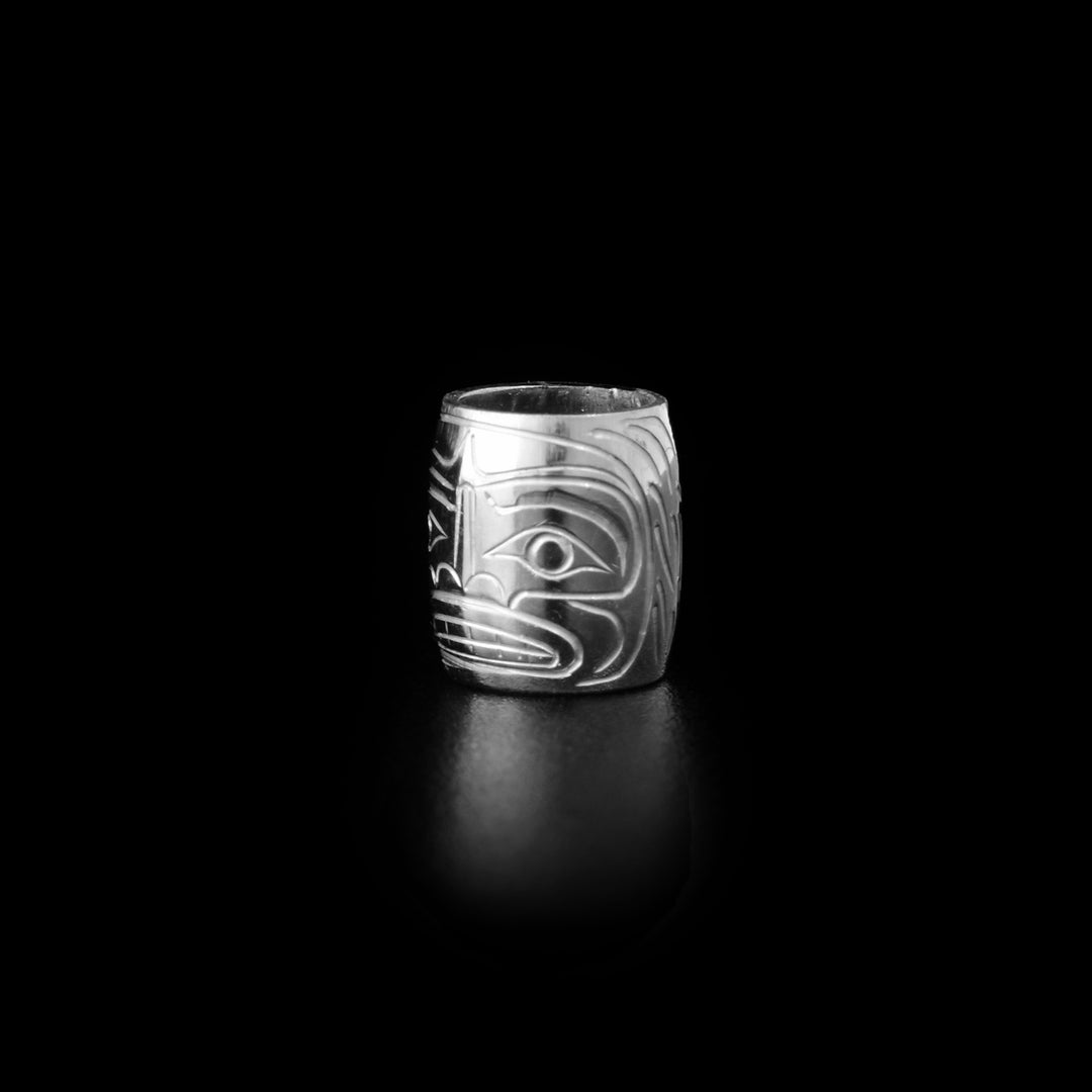 This bead charm is made from sterling silver and there is a depiction of the sasquatch carved into the surface of the bead.