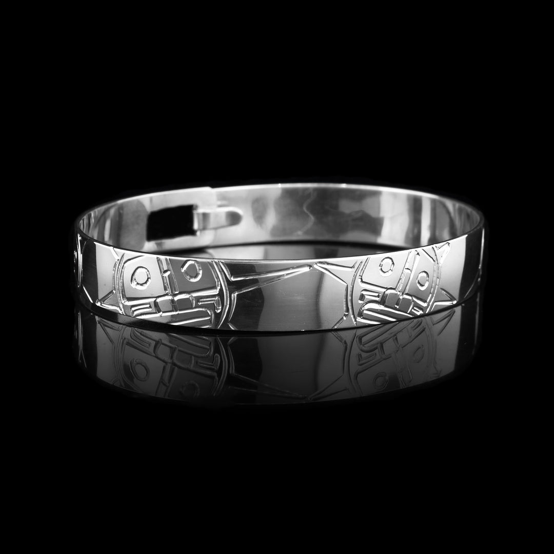 Elegant sterling silver bangle bracelet featuring a hand-engraved legend of the sun carved around the bracelet.