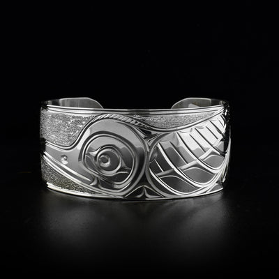 Sterling silver cuff bracelet featuring hummingbird. Textured background. Hand-carved by Kwakwaka’wakw artist Paddy Seaweed.