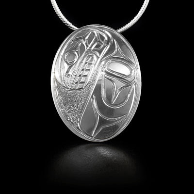 Oval sterling silver pendant featuring orca with textured background. Hidden bail on back. By Kwakwaka’wakw artist Paddy Seaweed.