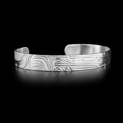 Sterling silver cuff bracelet featuring a bear with textured background. 0.38” wide. Hand carved by Kwakwaka’wakw artist Cristiano Bruno.