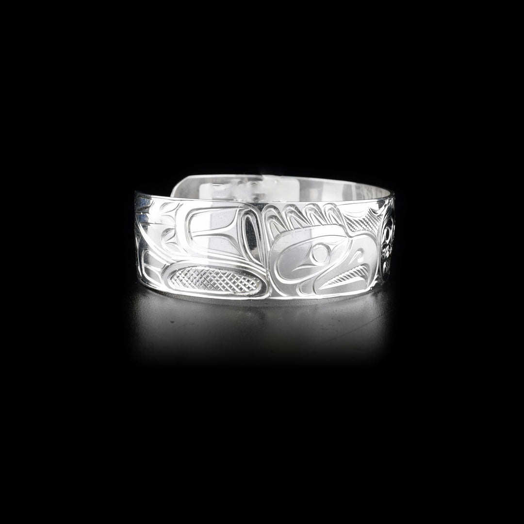 Right side of sterling silver cuff bracelet featuring two eagles and the moon.