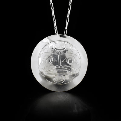 Sterling silver pendant depicting full moon with glow.