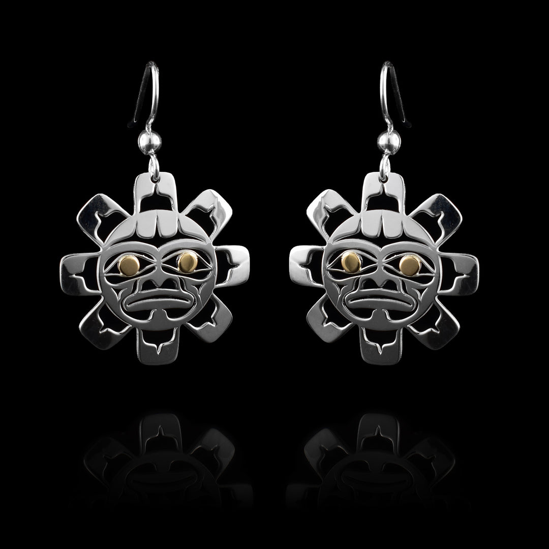 These Sun shape earrings  are made with sterling silver with 14k golden eyes hand crafted into the cut out shape of the Sun. A definitive face carved in indigenous style. 