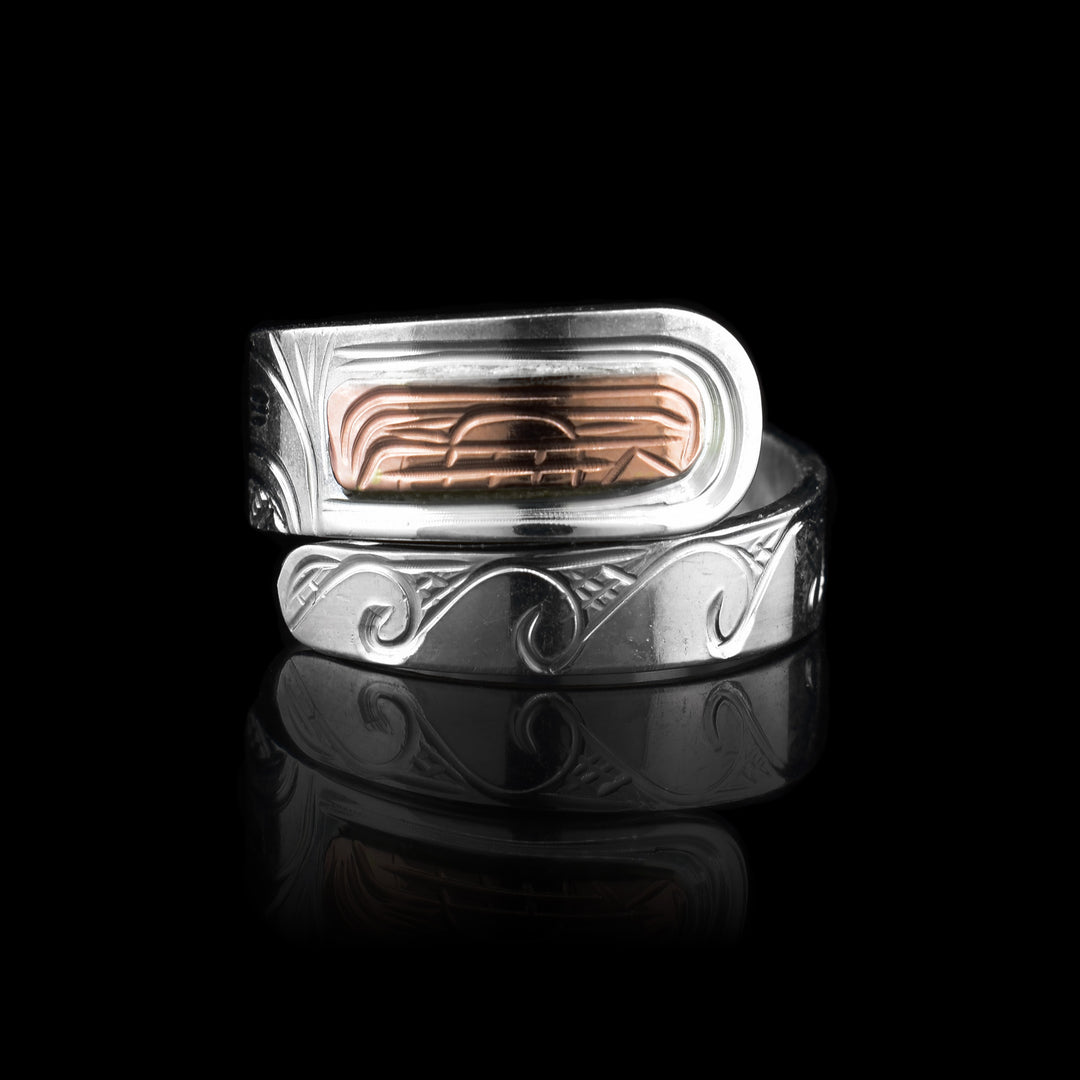 This beautiful Silver and Copper Orca Wrap Ring is made with sterling silver for the band the lower half is carved with ocean waves. The top half has the orca carved in making the orcas face made of copper.