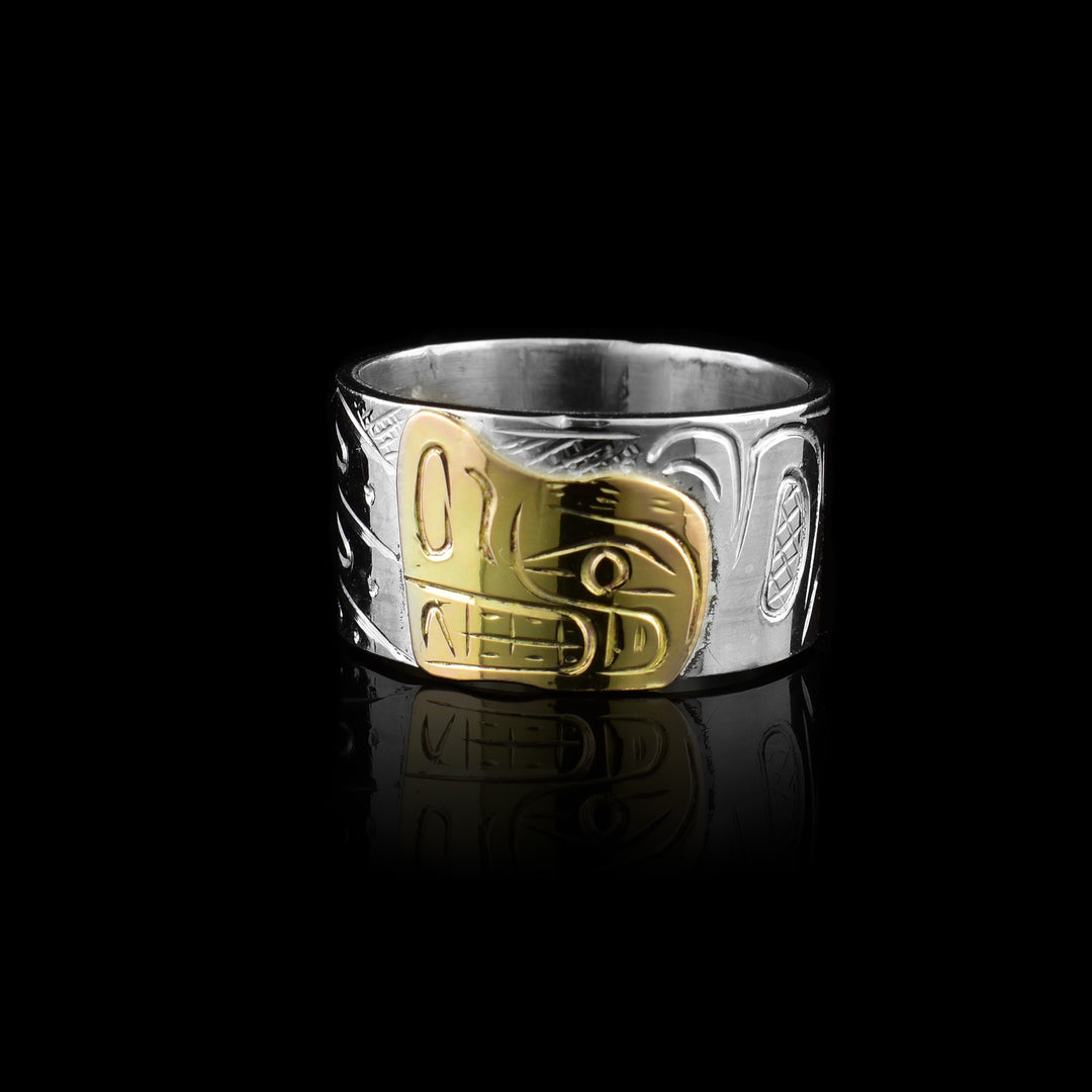 This Graham Henry band made of sterling silver and 10k gold. Featuring a hand-carved Bear legend in gold against a silver band.
