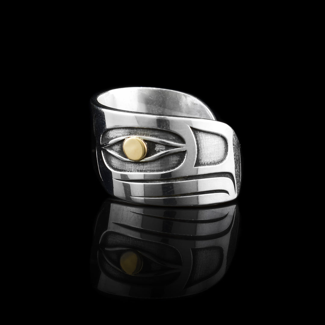 This sterling silver and 14K gold Eagle wrap ring has a depiction of the Eagle that makes a full wrap. The tip of the beak to the back of the head with a 14k gold eye.