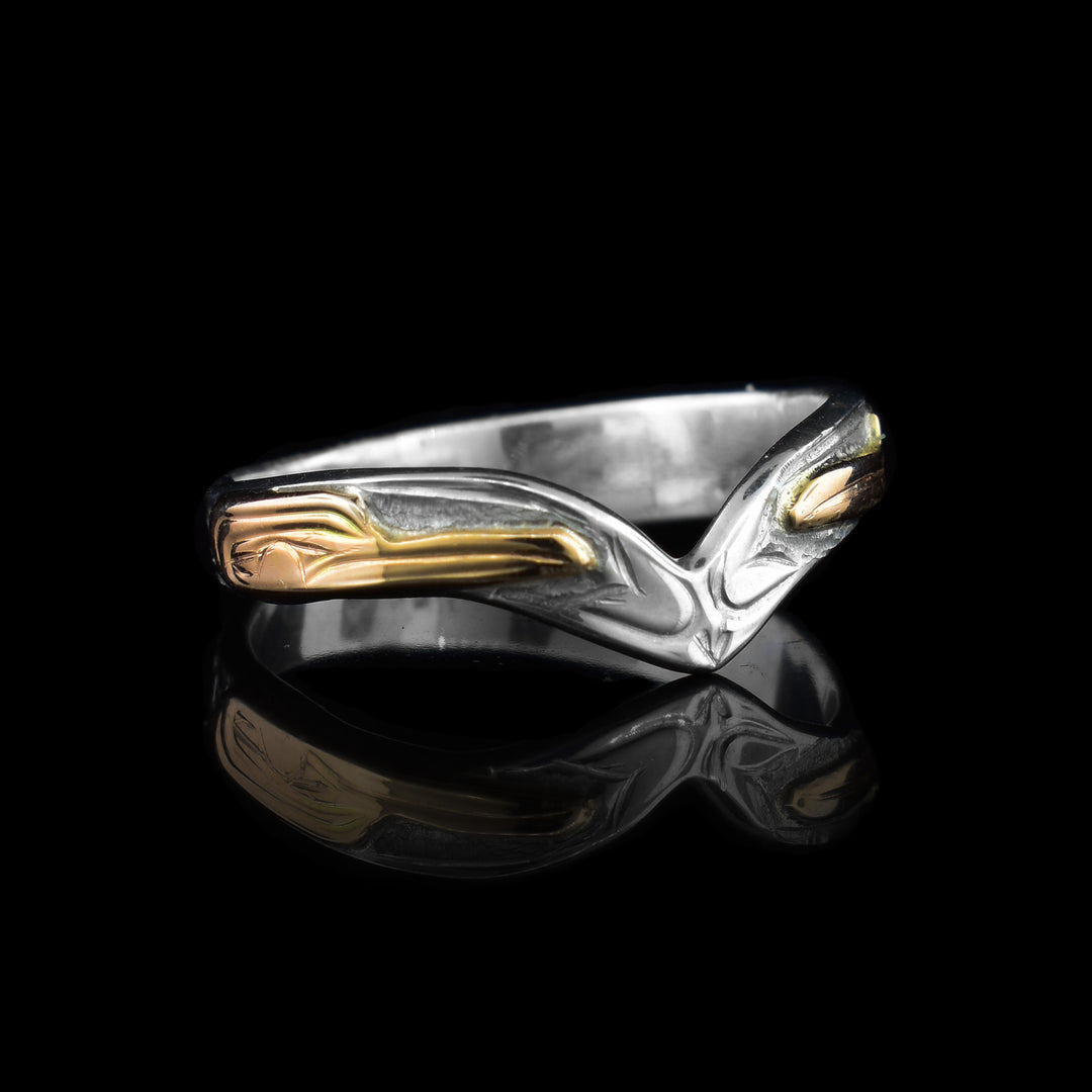 This Silver and Gold Hummingbird V-Ring has been hand carved the sterling silver band makes a V formation at the top of the ring. On either side is 14k gold hummingbird face.