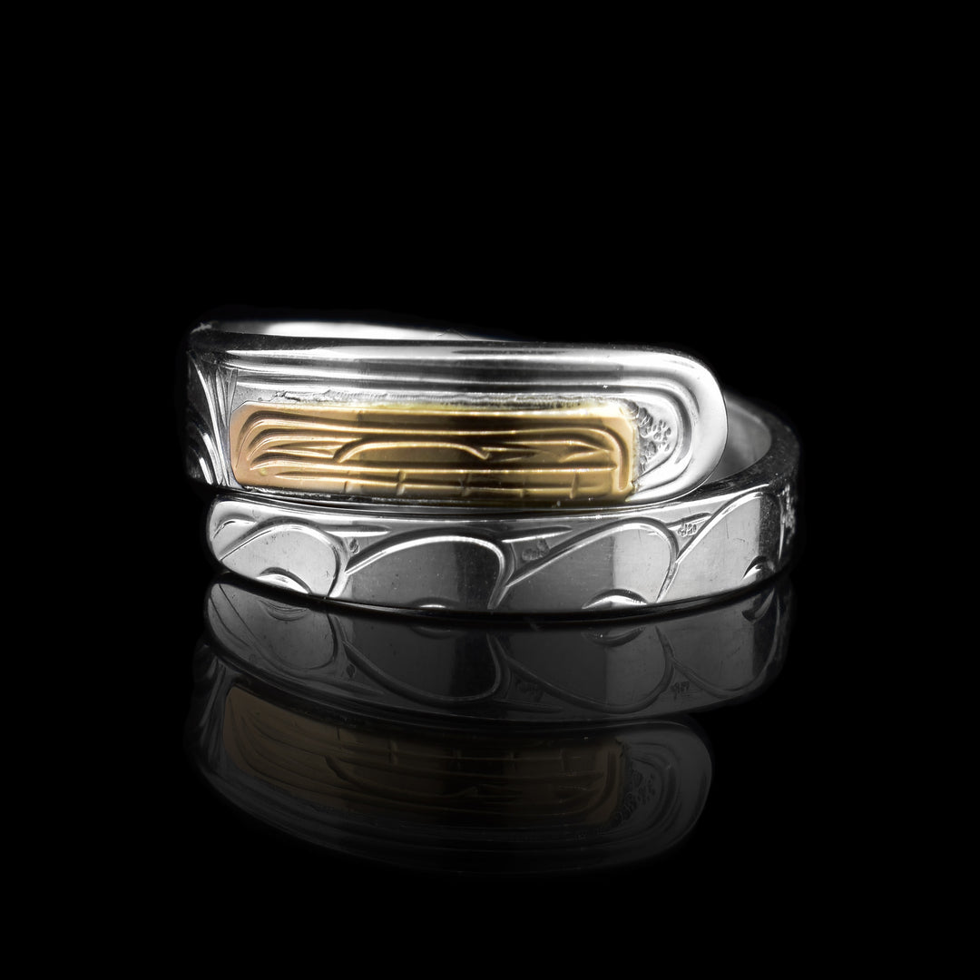 This beautiful Silver and Gold Orca Wrap Ring has two layer wrap. The bottom wrap is silver with hand-carved waves to represent the ocean. As the ring wraps to the top the waves form into the orca and finally ending on the gold orca face.