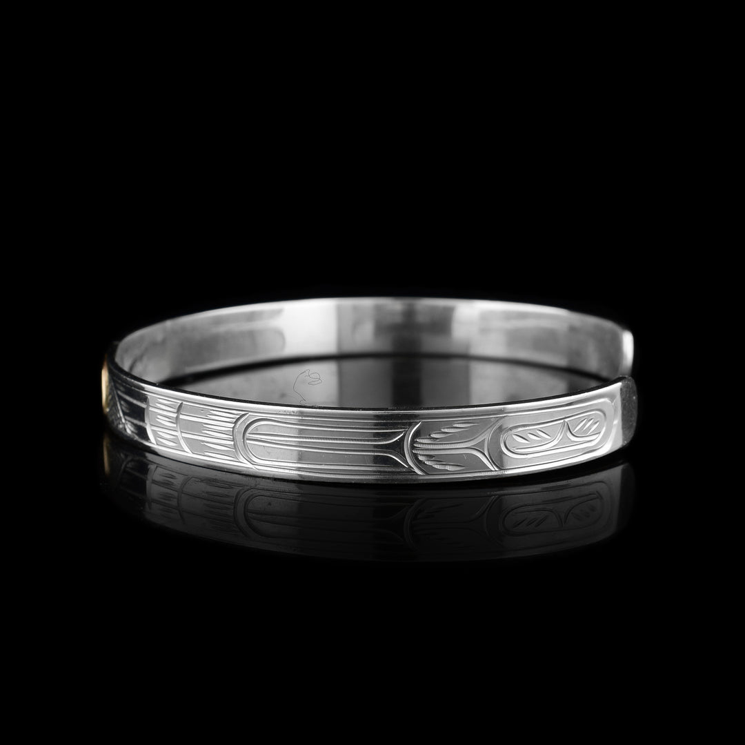 Right side photo of the raven bracelet shows carvings depicting more feathers belonging to the raven.