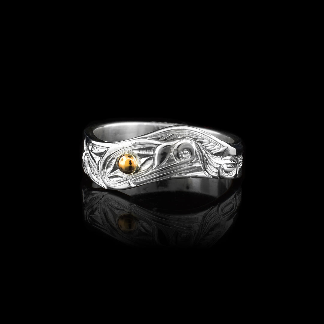 Silver and Gold Wavy Wolf Ring. With a 14k gold eye the rest is a wavy band of sterling silver carved with the indigenous legend of the wolf.
