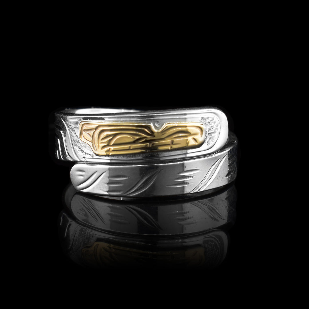 This elegant Silver and Gold Wolf Wrap Ring has two layers. The bottom layler is all sterling silver with etched markings that look like fur. As the ring wraps to the top the etchings turn into the legend of the wolf, making the gold piece at the op the wolfs head.
