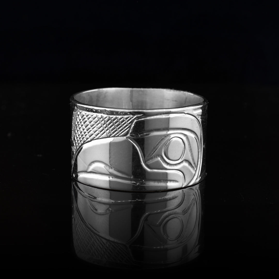 this sterling silver band ring with head of raven at the top. Carved designs on the rest of the ring depict the raven’s wing.