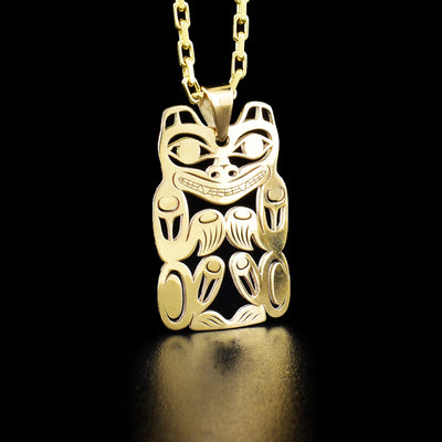 Small 14K yellow gold pierced bear pendant by Tahltan artist Grant Pauls.