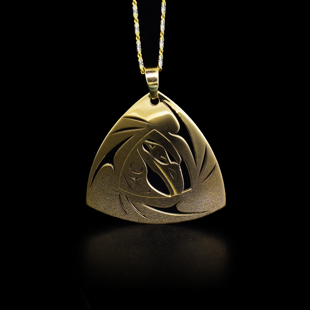 14K gold triangular raven pendant with pierced design. By Tahltan artist Grant Pauls.