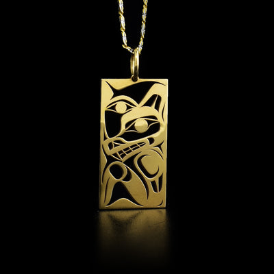Rectangular 14K gold wolf and moon pendant with jump ring. Pierced design. By Tahltan artist Grant Pauls.