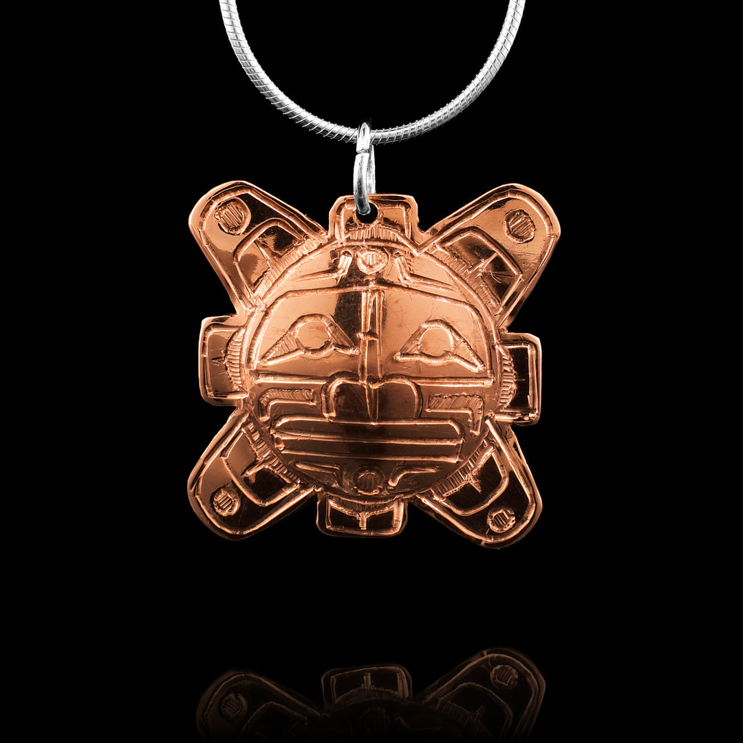 Copper Sun Pendant, cut out in the shape of the sun and has the legend of the Sun carved into it.