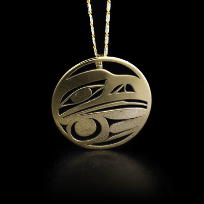 Round 14K gold raven pendant with hidden bail on back. Pierced design. By Tahltan artist Grant Pauls.