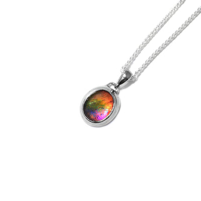 Oval AA-grade ammolite stone in sterling silver setting. Bail is sterling silver too. Ammolite has pink in it, as well as other colours.