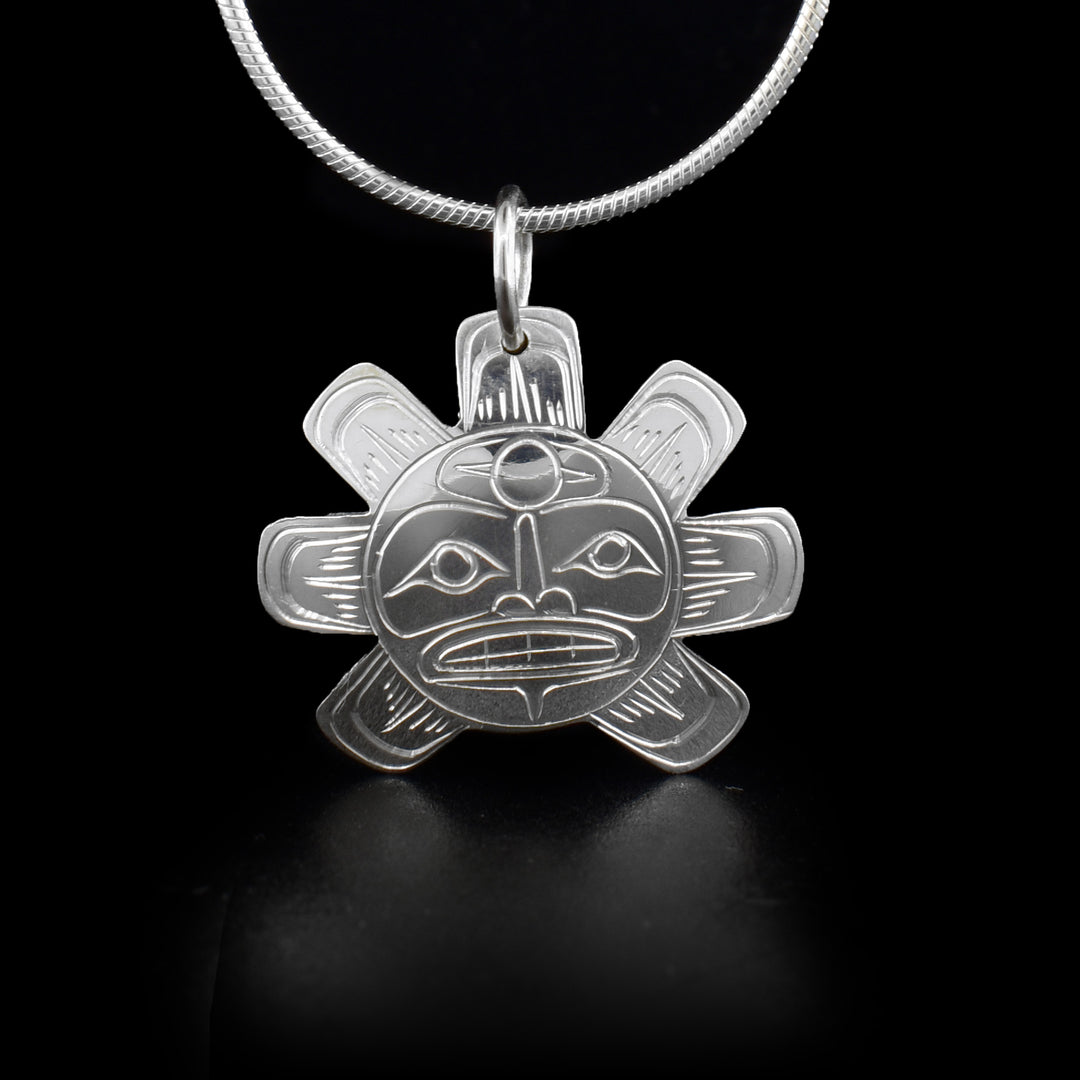 Sterling silver pendant depicting sun with seven rays.