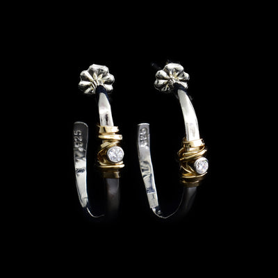 Sterling silver wavy hoop studs with gold-fill coil wrapped around front. Each earring has a cubic zirconia in the coil.