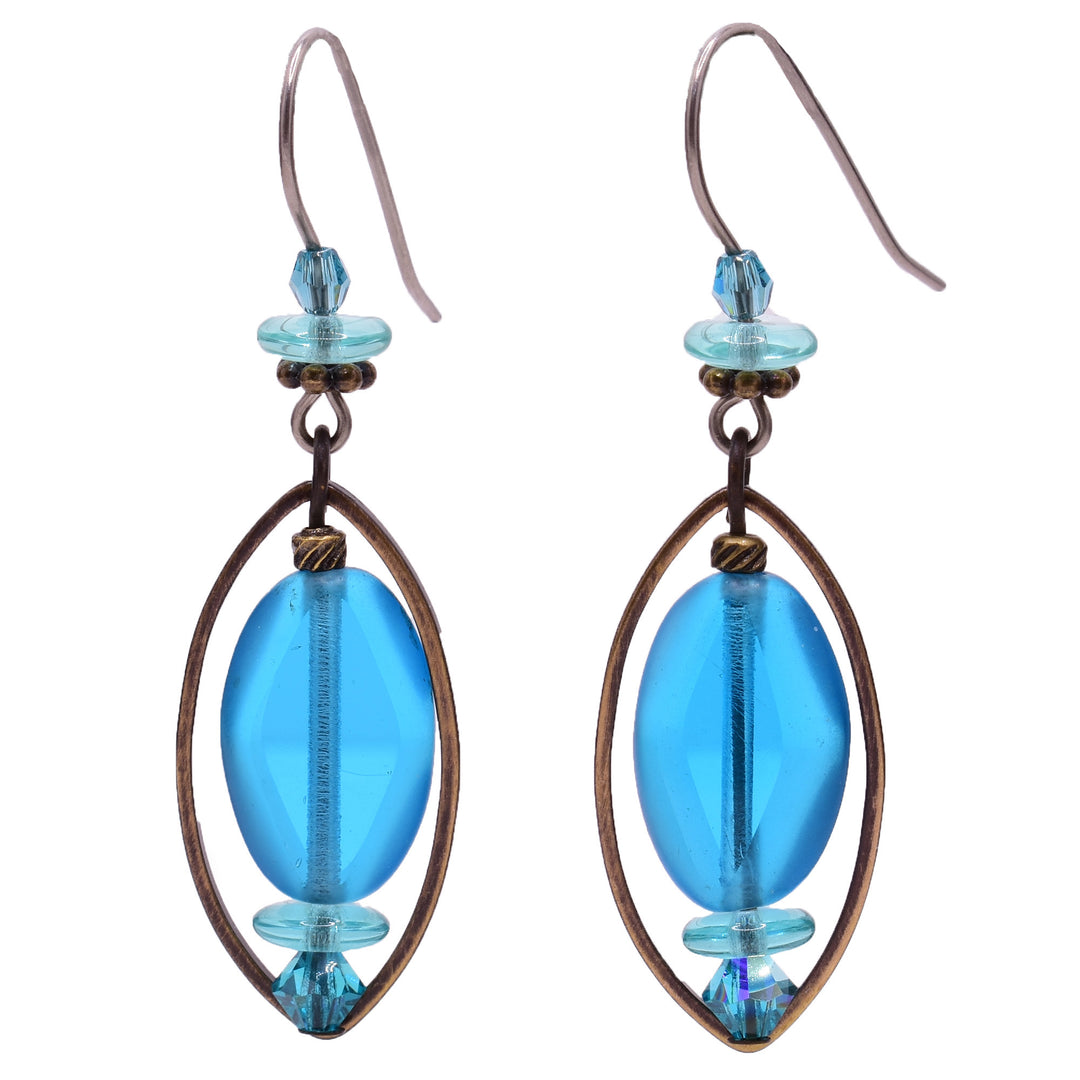 Dangle earrings made of Swarovski crystal, handworked brass, and glass. Titanium hooks. By Honica.