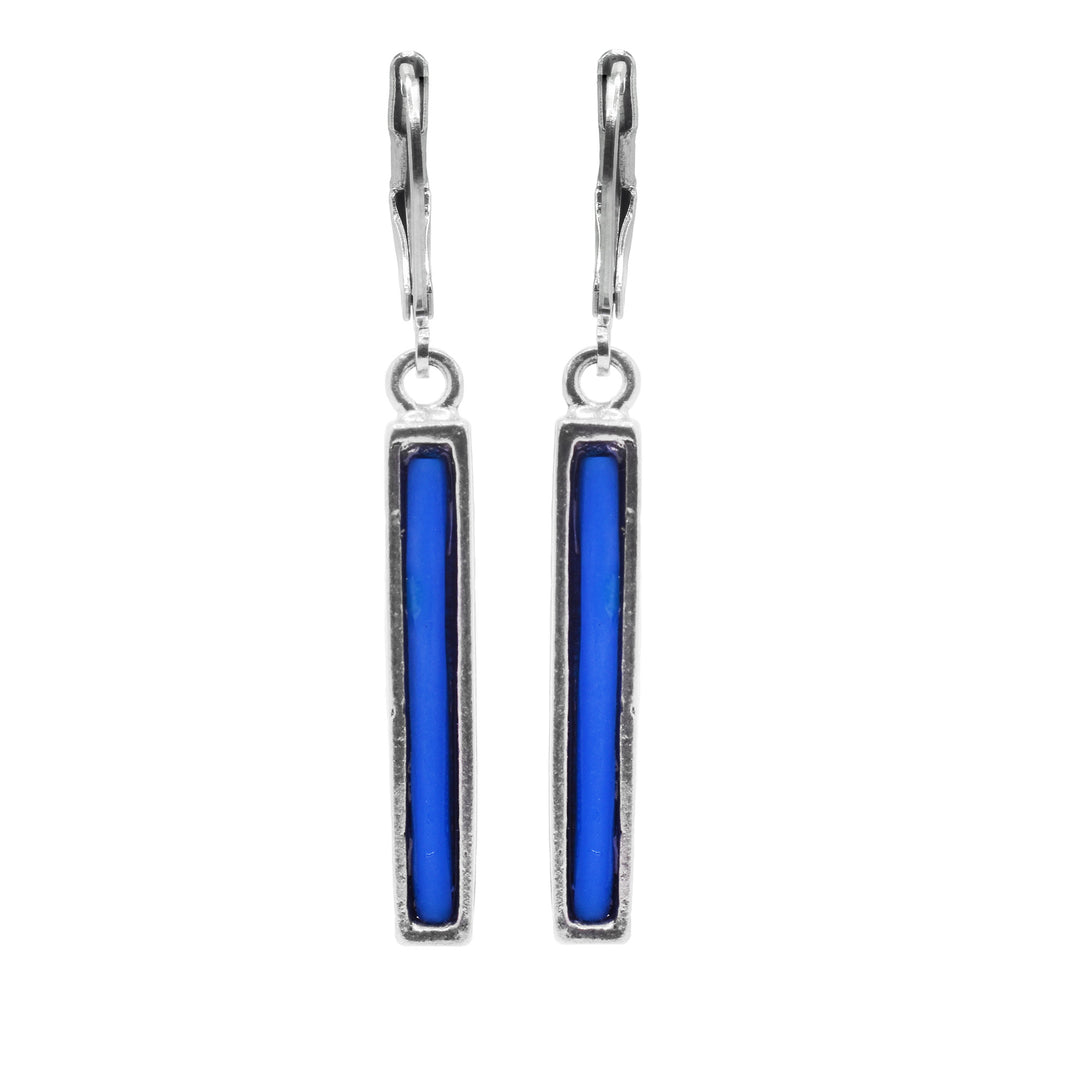 These dainty drop earrings have long, thin hangs made form pewter and rectangular in shape. The hangs dangle from stainless steel hooks and are filled with melted, blue glass.
