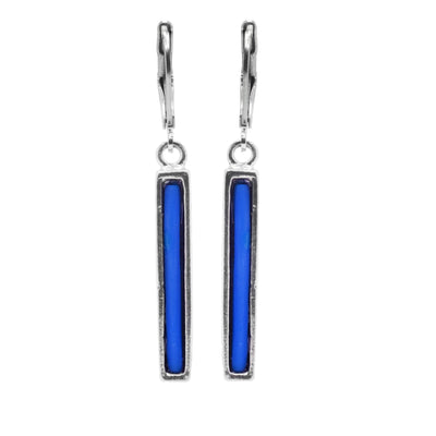 These dainty drop earrings have long, thin hangs made form pewter and rectangular in shape. The hangs dangle from stainless steel hooks and are filled with melted, blue glass.