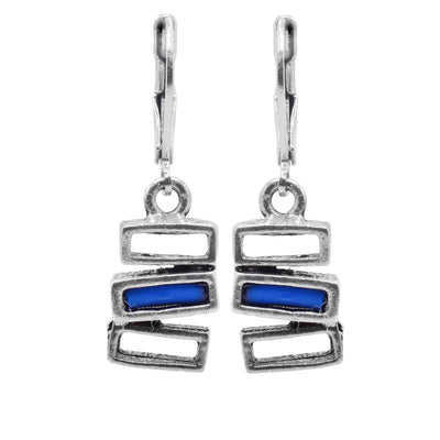 These pewter and blue glass rectangle dangle drop earrings have hangs that consist of three, horizontal rectangles stacked on top of each other. The rectangles are cutout and made from pewter, the center rectangle is filled with melted, blue glass.