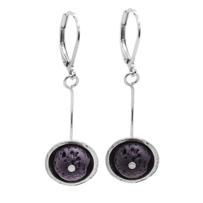 These circle drop earrings have pewter, half circles with black lava rocks held in them. There are pewter studs in the center of the rocks. The hangs are attached to long poles that drop down.