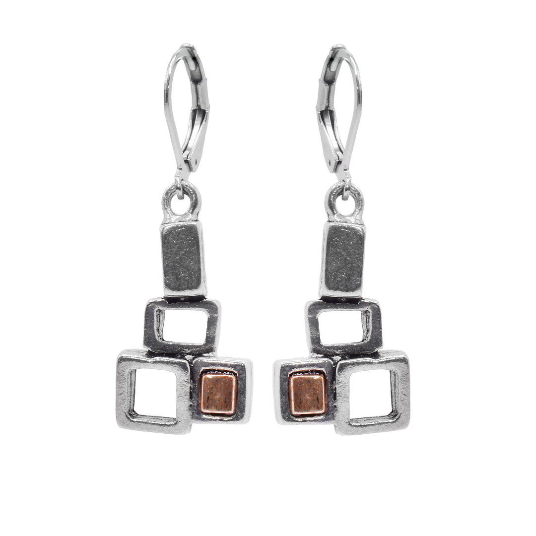 These dangling pewter earrings have hangs that consist of three cutout, pewter squares attached to each other. In one of the squares there is a gold, colored glass panel.
