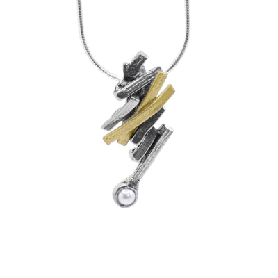 This abstract freshwater pearl pendant is made from several gold plated and pewter strips that are connected to make a jagged appearance. The piece drops down at an angle and has a round, freshwater pearl at the bottom of it.