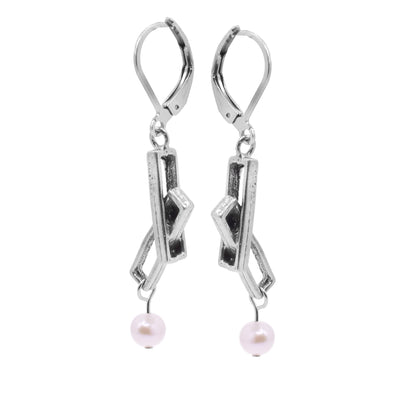 These pewter drop earrings consist of two, long and cutout rectangles that link through each other at an angle and drop down.. The hangs dangle drom stainless steel hooks and there are fresh water pearls dangling from the bottom of the hangs.