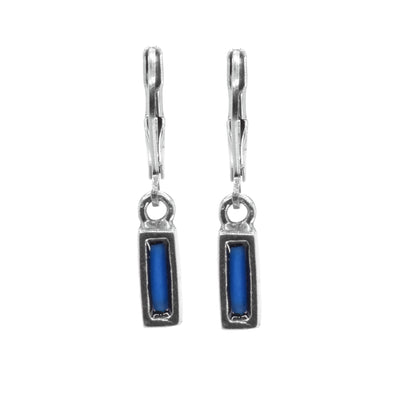 These dangling blue glass earrings have thin, rectangle hangs made from pewter that hang from stainless steel hooks. The pewter hangs are filled with melted, blue glass.
