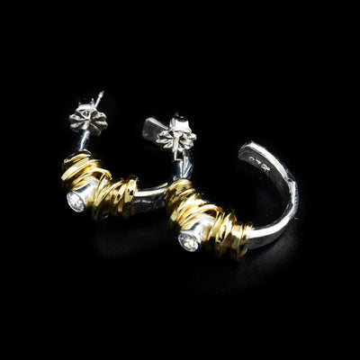 Sterling silver textured hoop studs with gold-fill coil wrapped around front. Each earring has a cubic zirconia in the coil.