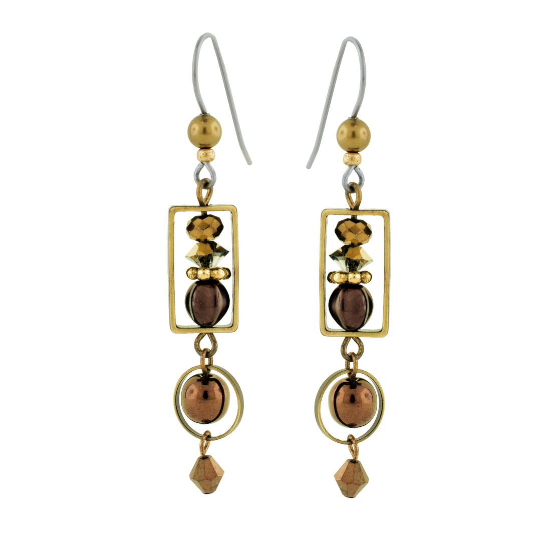 Shop these colored spiced gold drop earrings by artist Honica. Featuring a sleek antique brass rectangular frame surrounding a hand-picked mix of beads, pearls, and glass, these earrings offer a unique, artisanal aesthetic.
