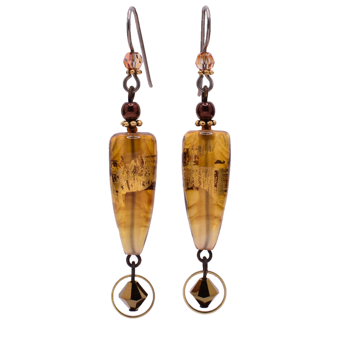 Dangle drop earrings made of Austrian crystal and BC artist studio glass with 23K gold leaf. Titanium ear hooks. By Honica.