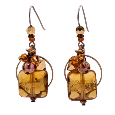 Dangle drop earrings made of Austrian crystal, glass, 25K gold leaf on glass, gold-plated Austrian crystal. Titanium ear hooks. By Honica.