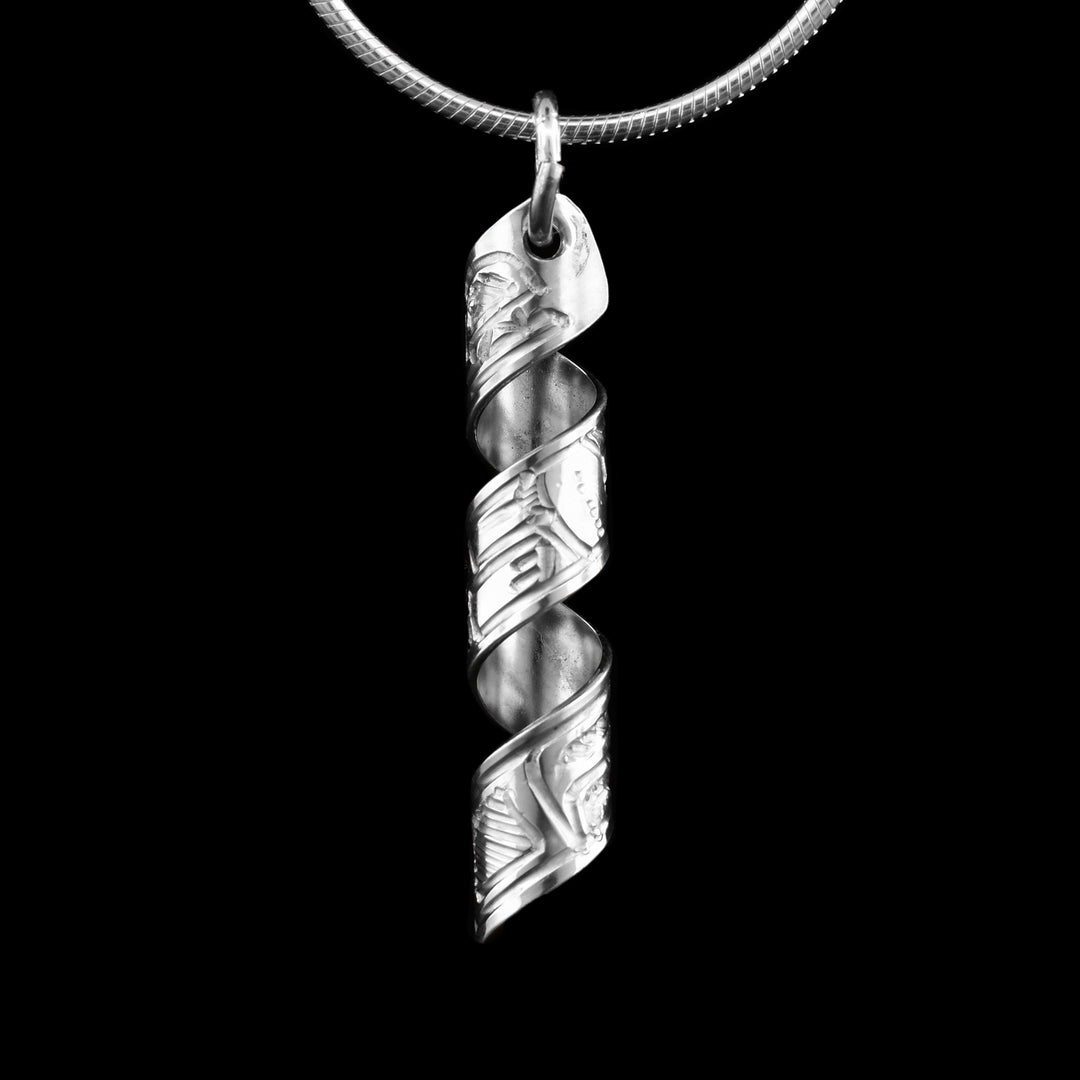 This Wolf spiral pendant is made out of a sterling silver strip which has the face and body of the Wolf carved on it and then coiled into a spiral.