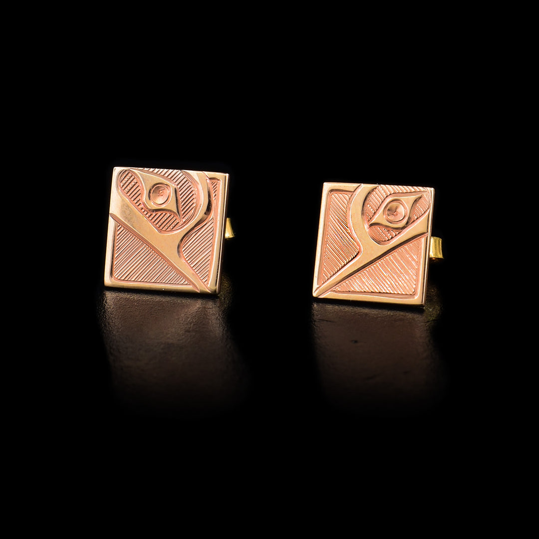 These Hummingbird earrings studs feature hummingbird heads coming out of corner with thin lines as part of the design and in the background. Hand-carved by Haisla artist Hollie Bartlett.