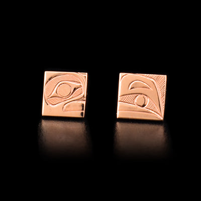 When the earrings are placed next to each other, they create the image of a raven head with a ball in between the beak. Hand-carved by Haisla artist Hollie Bartlett.