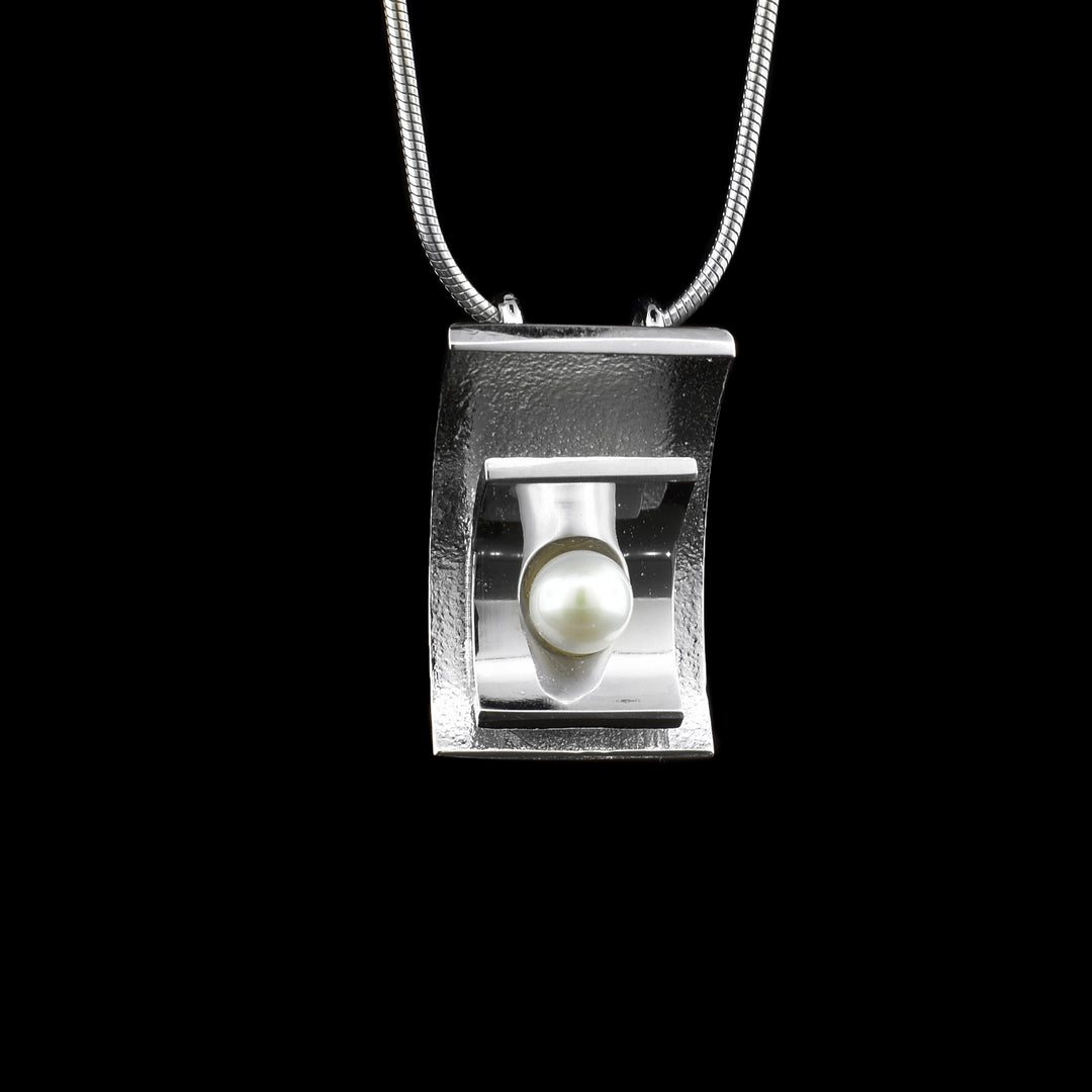 Square Silver and Pearl Necklace made with a sterling silver square pendant in the middle sits a fresh water pearl. 